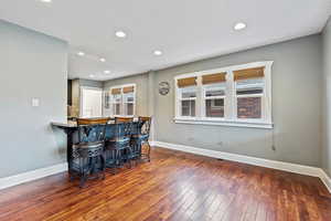 Bar with hardwood / wood-style flooring