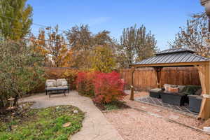 View of yard with outdoor lounge area, a gazebo, and a patio