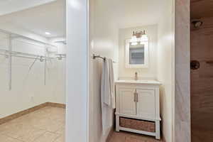 Bathroom featuring tile patterned floors and vanity