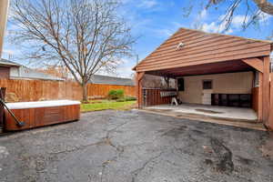 View of patio with a hot tub