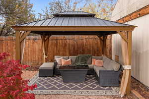 View of patio featuring a gazebo and an outdoor living space