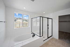 Bathroom featuring tile patterned flooring and plus walk in shower