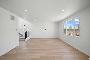 Unfurnished room with light wood-type flooring