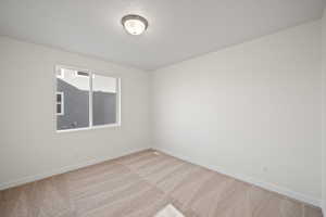 Unfurnished room with light colored carpet