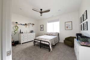 Carpeted bedroom featuring ceiling fan