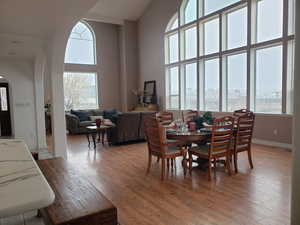 Dining room featuring hardwood / wood-style flooring and a high ceiling