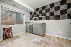 Interior space featuring gray cabinets and beverage cooler