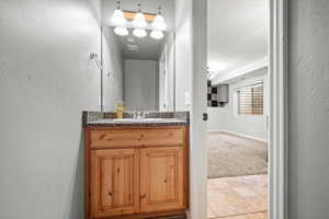 Bathroom featuring tile patterned flooring and vanity