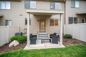 Back of property featuring a patio and central AC unit