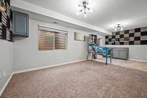 Playroom featuring carpet floors and a chandelier