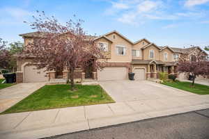 View of front of house with a front lawn and a garage