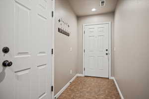 Doorway to outside with tile patterned flooring