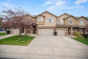 View of front of house with a garage and a front yard