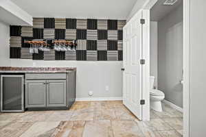 Bathroom with toilet and wine cooler