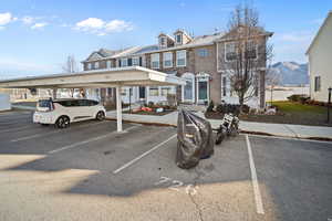 View of front of house with a mountain view and a carport