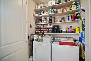 Clothes washing area featuring washing machine and dryer