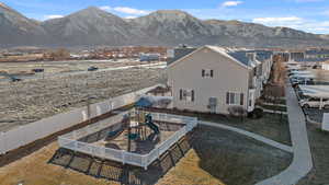 Rear view of property featuring a mountain view and a playground