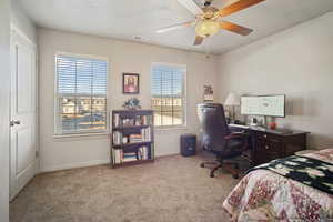 Bedroom featuring ceiling fan and light carpet