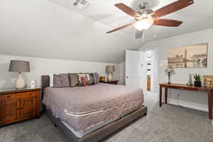 Bedroom with ceiling fan, carpet floors, and lofted ceiling