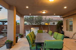 Patio terrace at dusk with a grill