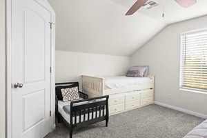 Bedroom with carpet flooring, ceiling fan, and vaulted ceiling