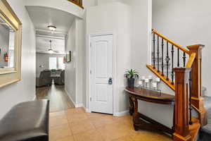 Entrance foyer with ceiling fan and light tile patterned flooring