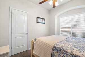 Carpeted bedroom with ceiling fan