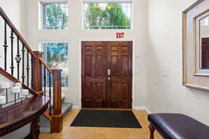 Entrance foyer with light tile patterned flooring and a towering ceiling