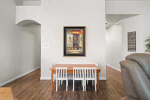 Dining area with dark hardwood / wood-style floors