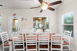 Dining space with ceiling fan and lofted ceiling