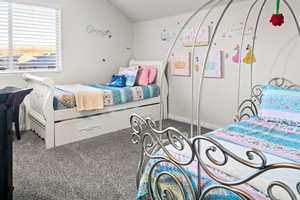 Carpeted bedroom with vaulted ceiling