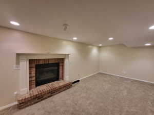 Living room with carpet and a brick fireplace