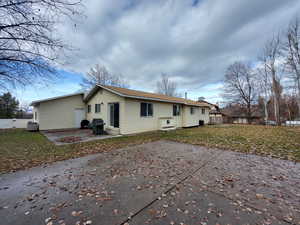 Rear view of house with a yard and a patio area