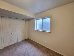 Unfurnished bedroom with carpet floors and a closet