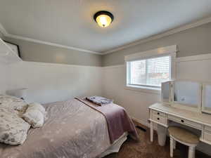 Bedroom featuring carpet and crown molding