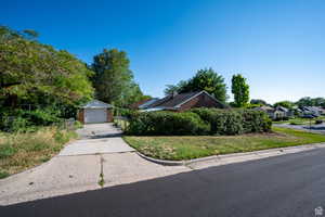 View of front of property featuring an outbuilding and a garage