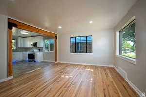 Unfurnished living room with light hardwood / wood-style floors