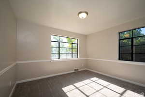 Spare room featuring carpet flooring