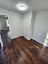 Unfurnished room with dark hardwood / wood-style flooring