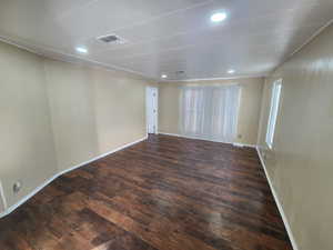 Unfurnished room with dark wood-type flooring