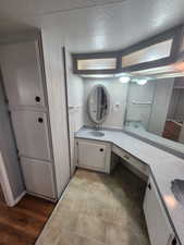 Bathroom with vanity and a textured ceiling