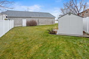 View of yard featuring a storage unit