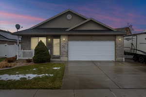 View of front of property with a lawn and a garage