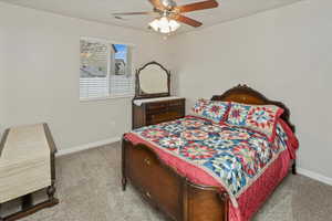 Carpeted bedroom with ceiling fan