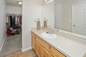 Bathroom with tile patterned floors and vanity