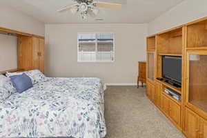 Bedroom with ceiling fan and carpet floors