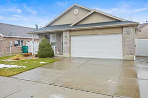 View of front of home featuring a front yard and a garage