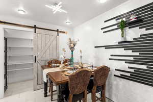 Tiled dining area with a barn door