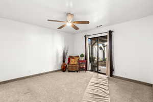 Sitting room with carpet flooring and ceiling fan