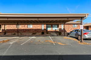 View of vehicle parking featuring a carport